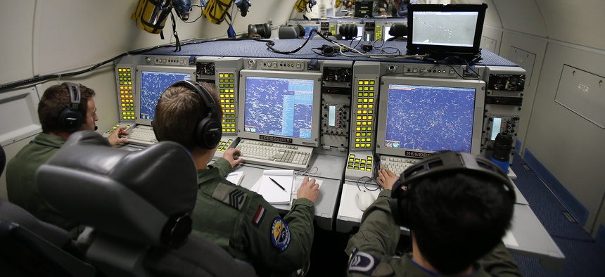 The E-3A AWACS Component crew of a NATO AWACS plane control computer and radar screens during a patrol over Romania and Poland, Friday, April 18, 2014.
