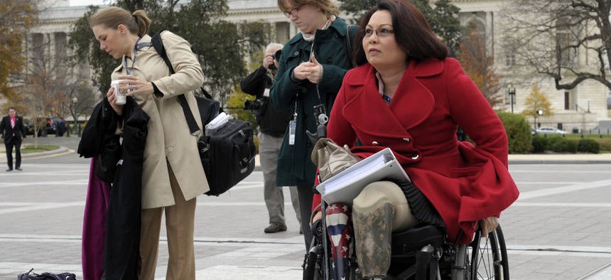 Rep. Tammy Duckworth, D-Ill., an Iraq War veteran who lost both legs in combat before turning to politics, arrives for a group photo on the East steps of the Capitol in Washington, Thursday, Nov. 15, 2012. (AP Photo/Susan Walsh)