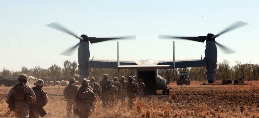 Marines with the Marine Rotational Force-Darwin load into an MV-22B Osprey during Exercise Koolendong at Bradshaw Training Field Area, Northern Territories, Australia.