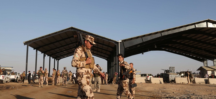 Kurdish Peshmerga fighters stand guard at the Khazer checkpoint outside of Irbil, Iraq, on August 8, 2014.