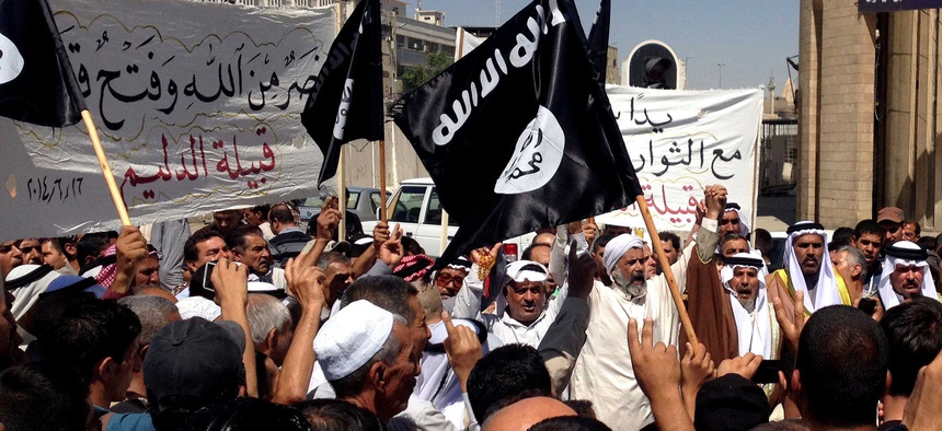Demonstrators in Mosul chant pro-ISIL cheers in front of the provincial government headquarters, on June 16, 2014.