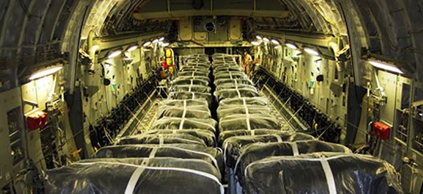 Pallets of bottled water are loaded aboard a U.S. Air Force C-17 Globemaster III aircraft in preparation for a humanitarian airdrop over Iraq, Aug. 13, 2014.