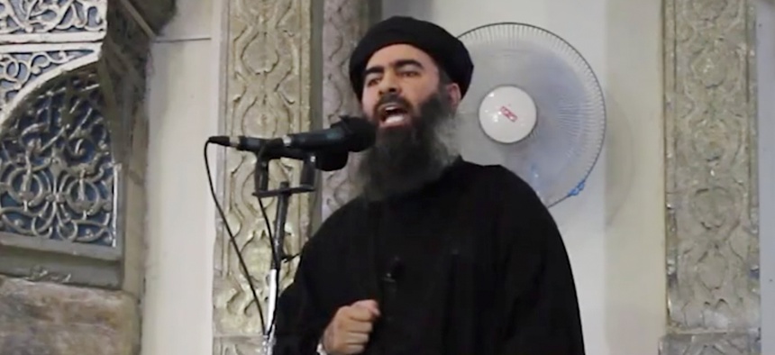 A screengrab from a militant website video Saturday, July 5, 2014, which has been authenticated based on its contents and other AP reporting, purports to show the leader of the Islamic State group, Abu Bakr al-Baghdadi, delivering a sermon at Iraq.