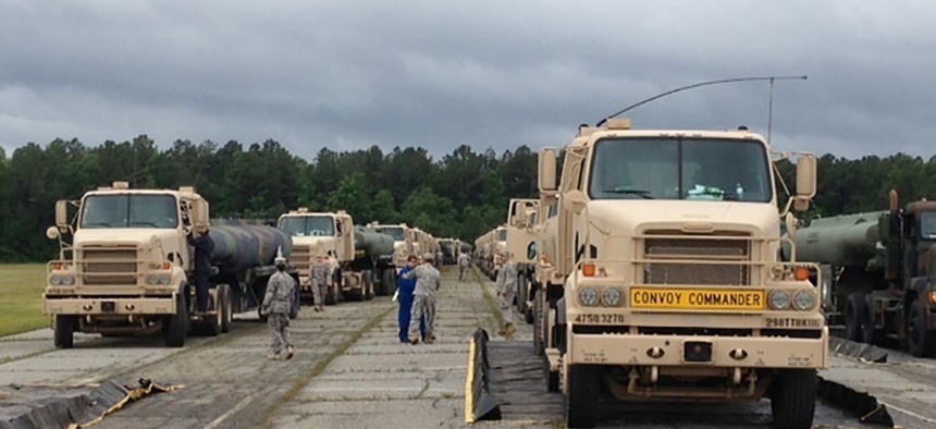 M915A5 line-haul tractor trucks line up at Fort Lee, Va., and prepare for a convoy to Fort A.P. Hill, Va., on June 3, 2013.