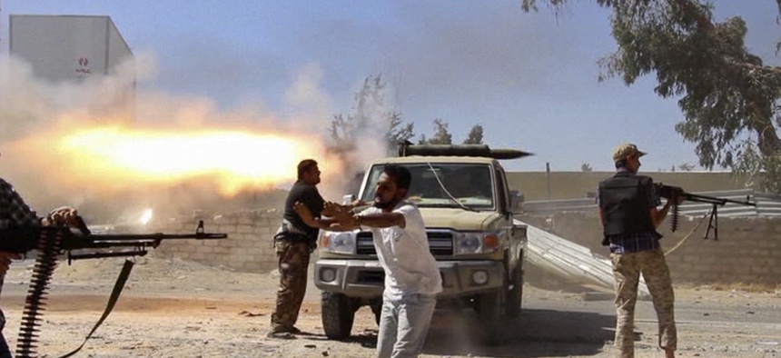 Fighters with the Misarata brigade fire towards Tripoli airport in an attempt to take control of the position from a rival militia, on July 26, 2014.