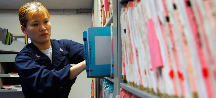 A Petty Officer files medical records aboard the USS Nimitz.