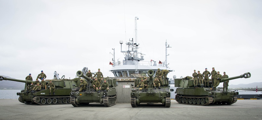 As part of NATO's Unified Vision 2014 exercise, a Norwegian artillery unit sets up its self-propelled howitzers.
