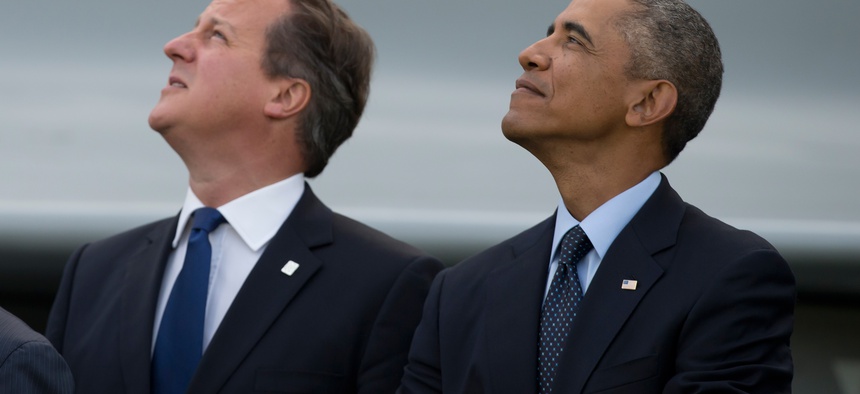 U.S. President Barack Obama and British Prime Minister David Cameron watch a flypast at the NATO summit at the Celtic Manor Resort in Newport, Wales on Sept. 5, 2014.