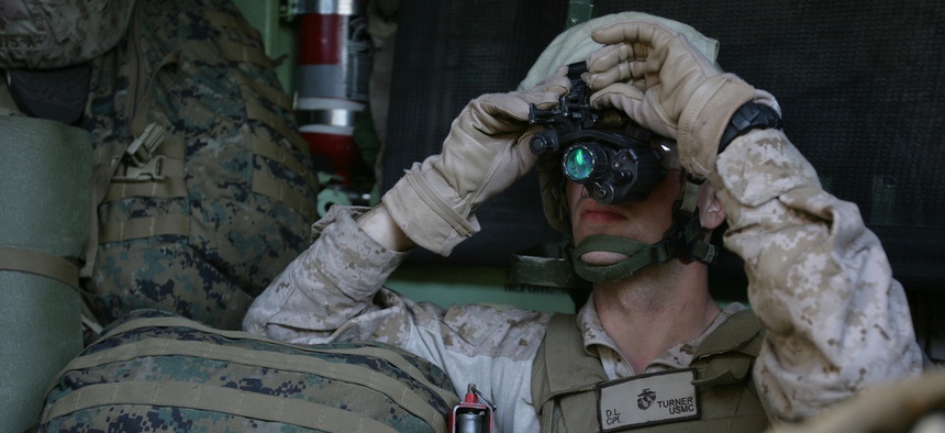 Cpl. Dustin Turner, a rifleman with the 1st Platoon, Company G, adjusts his night vision optics while riding in an Amphibious Assault Vehicle.