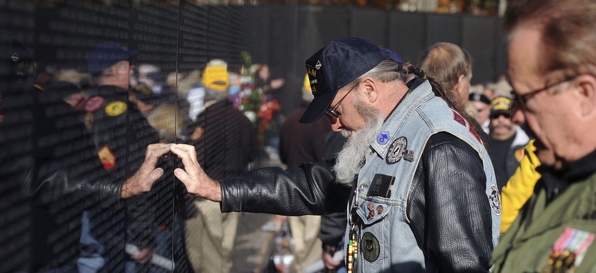A Vietnam War veteran participates in a ceremony during the 2013 Veterans Day event at the Vietnam War Memorial in Washington, D.C.