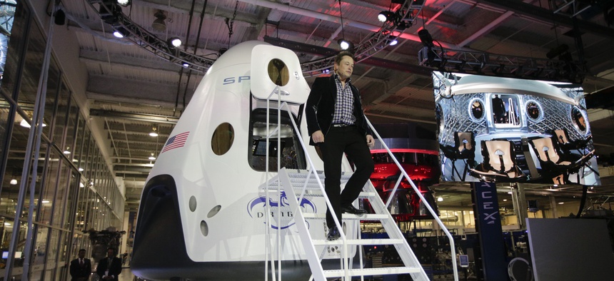 Elon Musk, CEO and CTO of SpaceX, walks down the steps as he introduces the SpaceX Dragon V2 spaceship at company headquarters in Hawthorne, Calif.