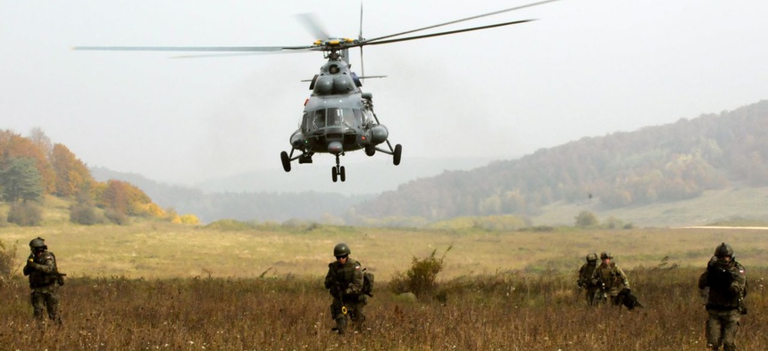 U.S. and Polish Special Operations Forces move across a field in Hohenfels, Germany, during a training exercise at the Joint Multinational Readiness Center.