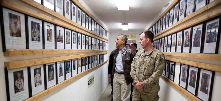 President Barack Obama and Brig. Gen. Erik Kurilla view photos of fallen military personnel at Bagram Airfield, Afghanistan, Sunday, May 25, 2014.