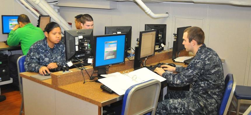 Sailors use computers to check their personal emails aboard the USS Carl Vinson.