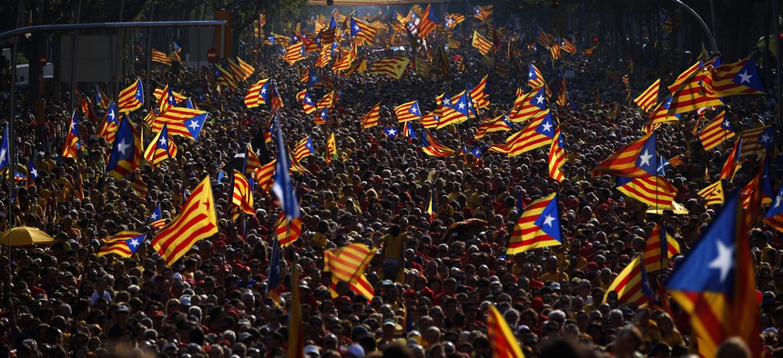 People wave flags symbolizing Catalonia's independence during a demonstration in Catalonia, Spain, on September 11, 2014.