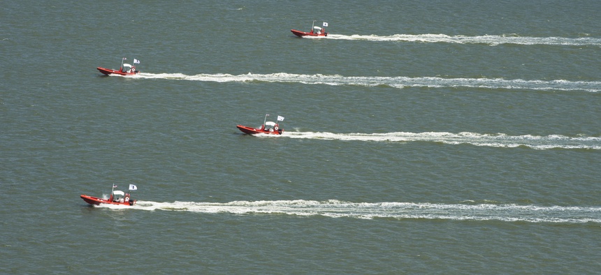 A group of autonomous swarm robots conduct operations on the James River.