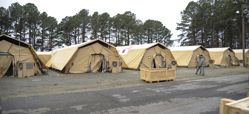 Teams from the 633rd Medical Group team up with the San Antonio Military Medical Center at Langley AFB to test a new tent structure for the Expeditionary Medical Support System, on February 3, 2014.