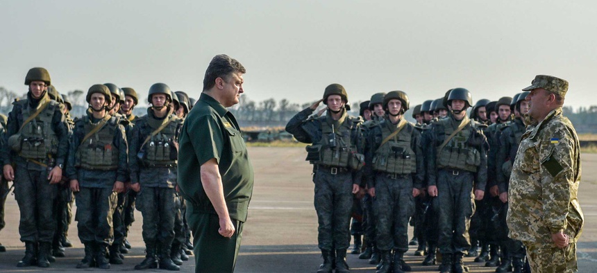 Ukrainian President Petro Poroshenko inspect military personnel during his visit to Mariupol, Ukraine, on September 8, 2014.