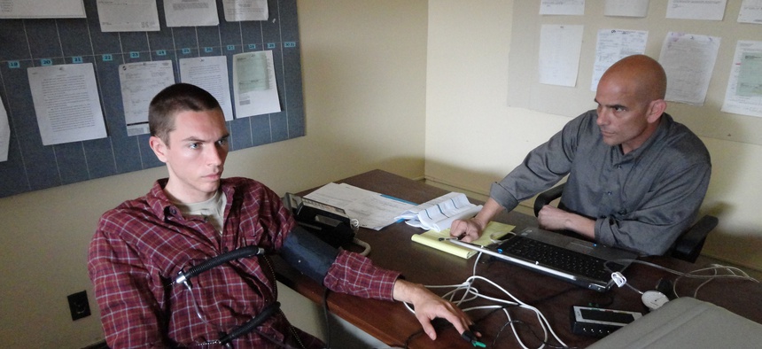 A photo of a man undertaking a polygraph test.