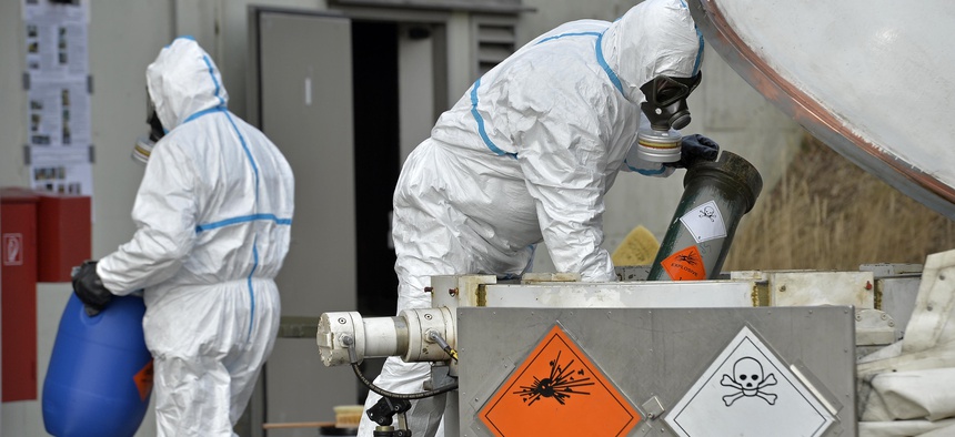 Experts at GEKA, a German state-run company, demonstrate the proper way to dispose chemical weapons. The company was tasked with dismantling Syria's chemical weapons program.