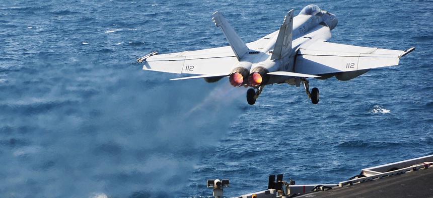 An F/A 18 Super Hornet launches from the flight deck of the USS George H.W. Bush while supporting operations against ISIS, on October 13, 2014.