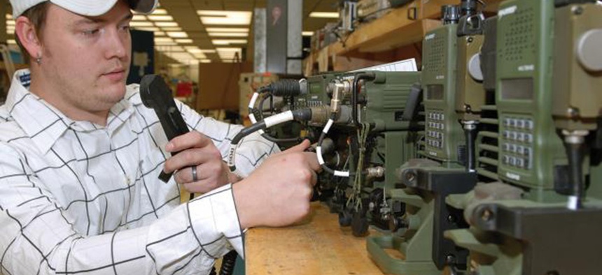 A technician at Tobyhanna Army Depot performs a system check on a series of radio systems.