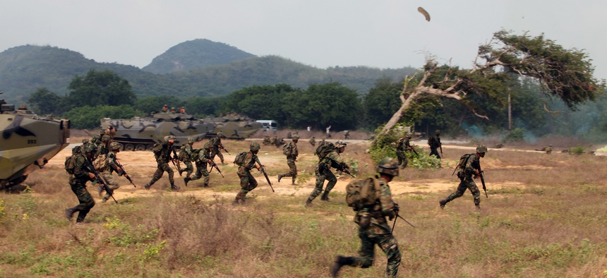 Royal Thai Marines hit the beach and move towards their objectives during an amphibious assault demonstration alongside U.S. Marines during Exercise Cobra Gold 13.
