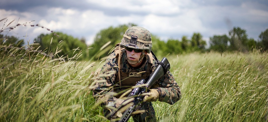 A corporal with the Black Sea Rotational Force 13 moves to his ambush position during a live-fire exercise in the Balta Verde Training Center in Romania, on March 14, 2013.