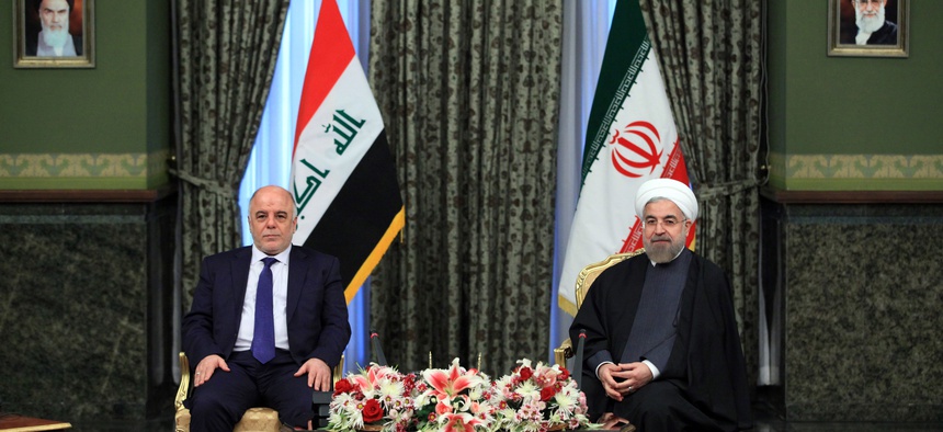 Iraqi Prime Minister Haidar al-Abadi (left) meets with Iran's President Hassan Rouhani at Tehran's Saadabad Palace, on October 21, 2014.