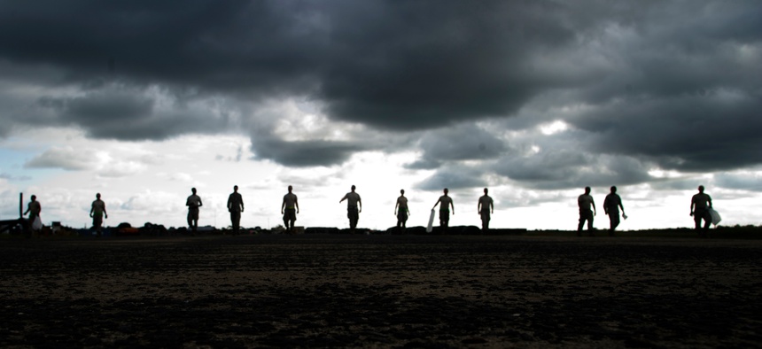 U.S. Airmen with the 621st Contingency Response Wing conduct a foreign object debris walk in Monrovia, Liberia, during Operation United Assistance Oct. 28, 2014.