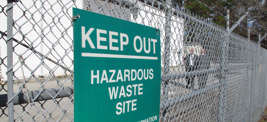 In a Feb. 27, 2013 file photo, a sign cautions visitors outside a "pump and treat" facility on the Marine base at Camp Lejeune, N.C. The sprawling installation is the site of one of the worst drinking water contaminations in U.S. history.