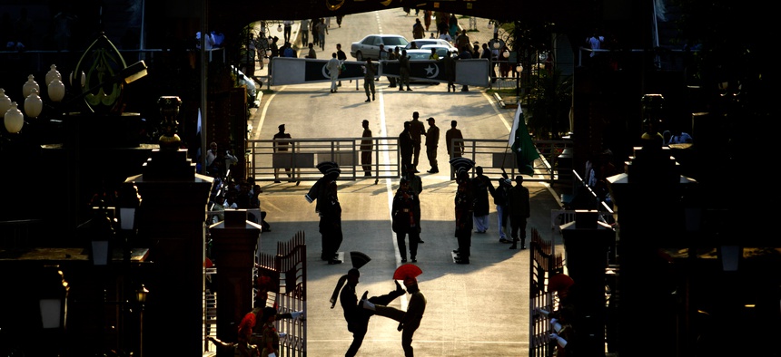 In this photo taken on April 17, 2012, an Indian Border Security Force soldier and a Pakistani Ranger take part in a daily retreat ceremony at the Joint Check Post at Wagah near Amritsar, India.