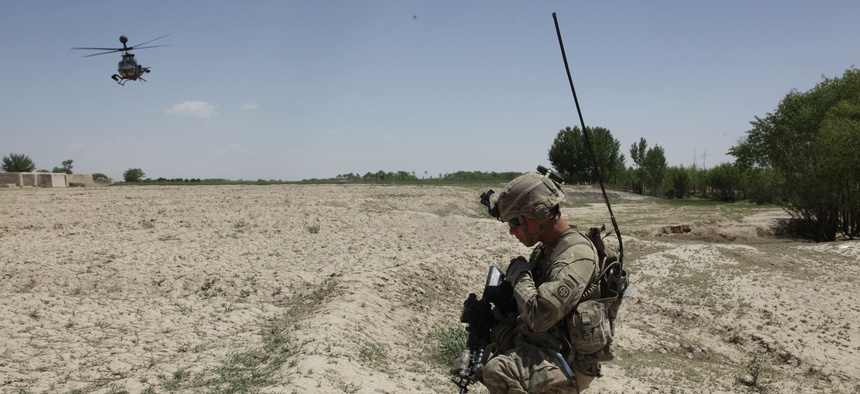 An Army sergeant communicates with air support during a cordon and search in the Ghazni province, Afghanistan, on May 18, 2012.