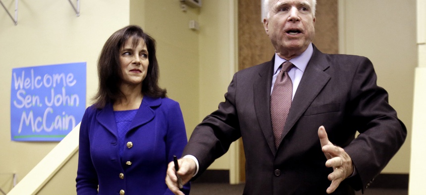Arizona Sen. John McCain stands with Senate Candidate Monica Wehby (left) during a campaign event on October 2, 2014.