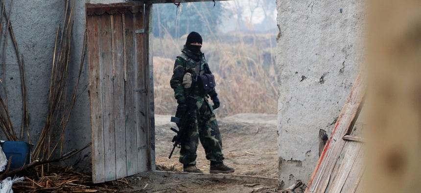 An Afghan National Army commando with the 1st Tolai, 6th Special Operations Kandak provides security during an operation in the Bati Kot district, Nangarhar province, Afghanistan, Jan. 10, 2014.