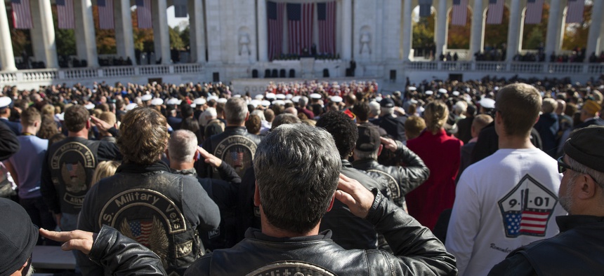 Military veterans salute during the annual Veterans Day Observance Ceremony at Arlington National Cemetery in Arlington, Va., on Tuesday, Nov. 11, 2014.