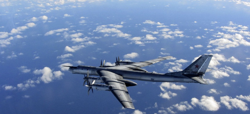 A Russian long range bomber aircraft is intercepted by a British Royal Air Force jet, on October 29, 2014.