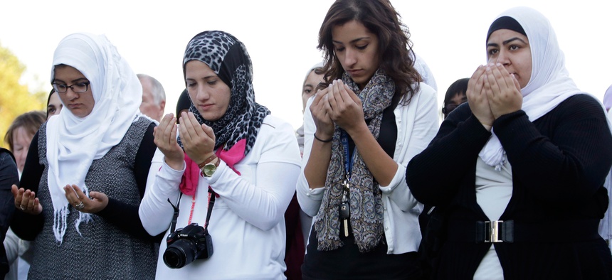 Attendees pray at a vigil for Abdul-Rahman Kassig, who last week was named the next beheading target of the Islamic State terror group, at Butler University, Wednesday, Oct. 8, 2014 in Indianapolis.