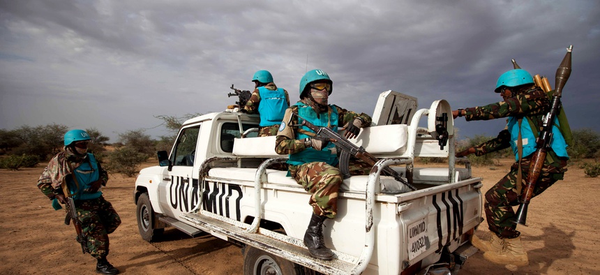 Tanzanian United Nations African Union Mission in Darfur (UNAMID) troops patrol Khor Abeche, South Darfur, Sudan, July 1, 2014.