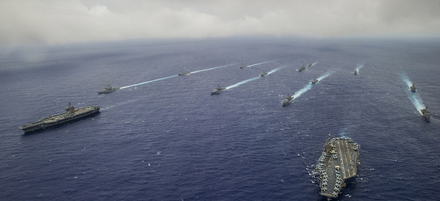 Ships from the George Washington and Carl Vinson Carrier Strike Groups are underway in formation at the conclusion of Valiant Shield 2014