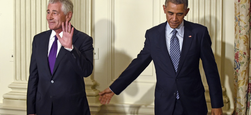 Defense Secretary Chuck Hagel stands with President Obama following an announcement where Hagel announced his resignation from the Pentagon.