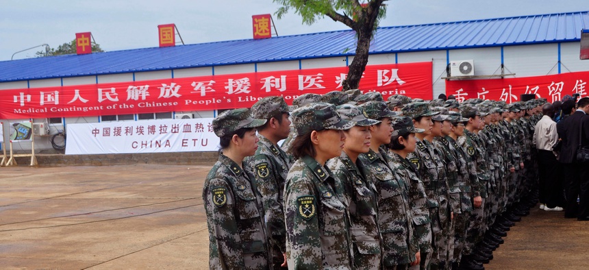 Chinese soldiers stand parade during the opening of a new Ebola virus clinic sponsored by China, in Monrovia, Liberia, on Nov. 25, 2014,