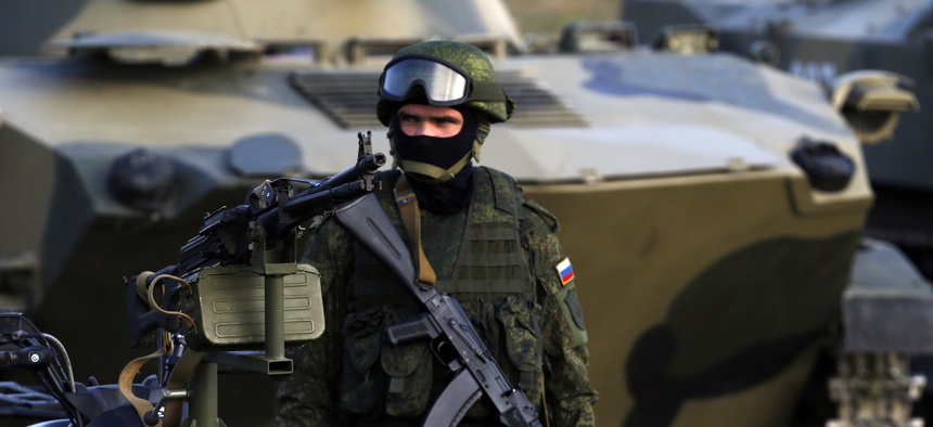 A Russian paratrooper stands guard during the Russian-Serbian joint antiterrorist exercise Srem 2014, at Nikinci training ground, 60 kilometers west of Belgrade, Serbia, Friday, Nov. 14, 2014.
