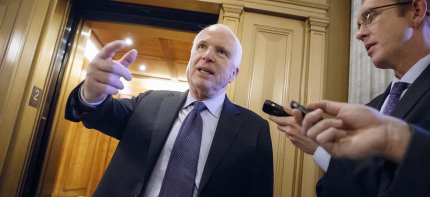Sen. John McCain, R-Ariz., who is poised to become chairman of the Senate Armed Services Committee in January, speaks to reporters off the Senate floor, on December 4, 2014