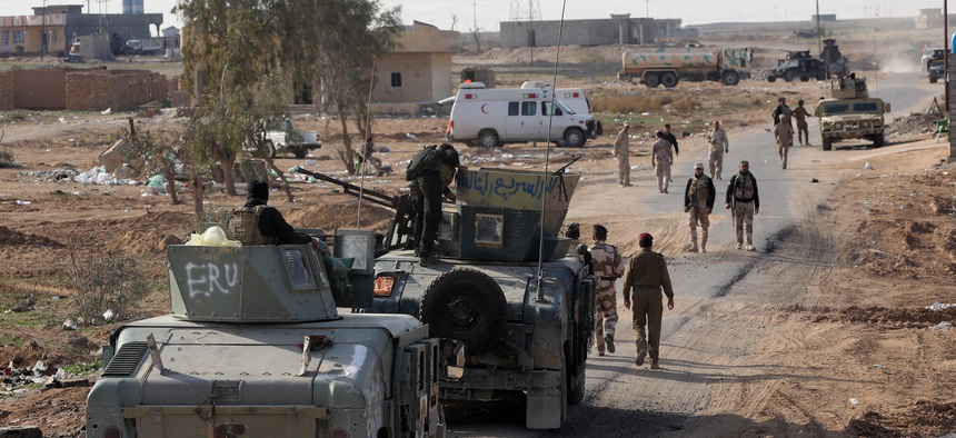Iraqi security forces are deployed during a military operation to control the villages around the town of Beiji, 250 kilometers north of Baghdad, on December 8, 2014.