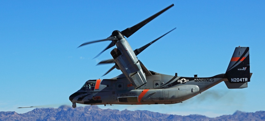 A V-22 Osprey fires a side-mounted rocket during a test at Yuma Proving Ground.