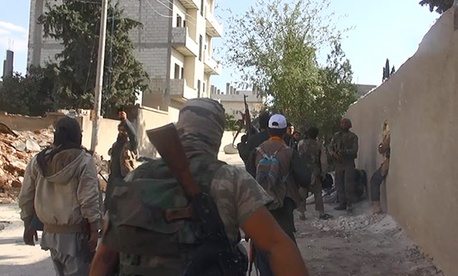 Islamic State fighters walk through the streets of Kobani, on November 4, 2014. Islamic State fighters walk through the streets of Kobani, on November 4, 2014.