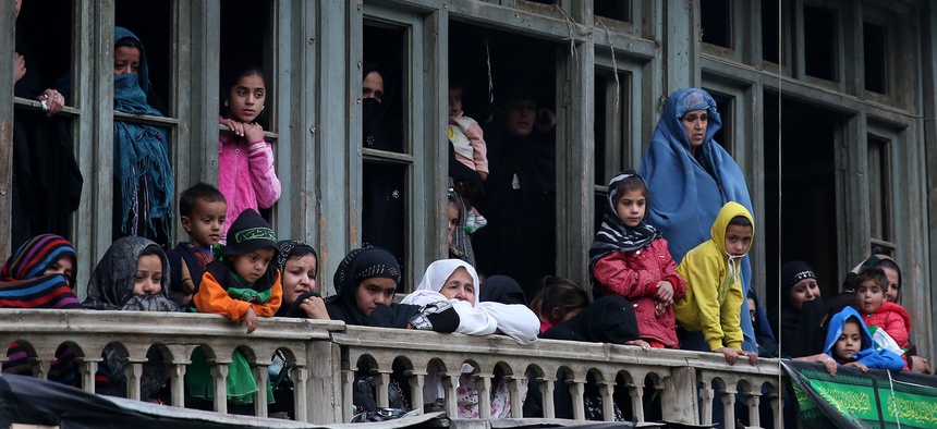 Afghan Shiite women watch a religious ceremony ahead of the Ashouraa holiday, on November 2, 2014.