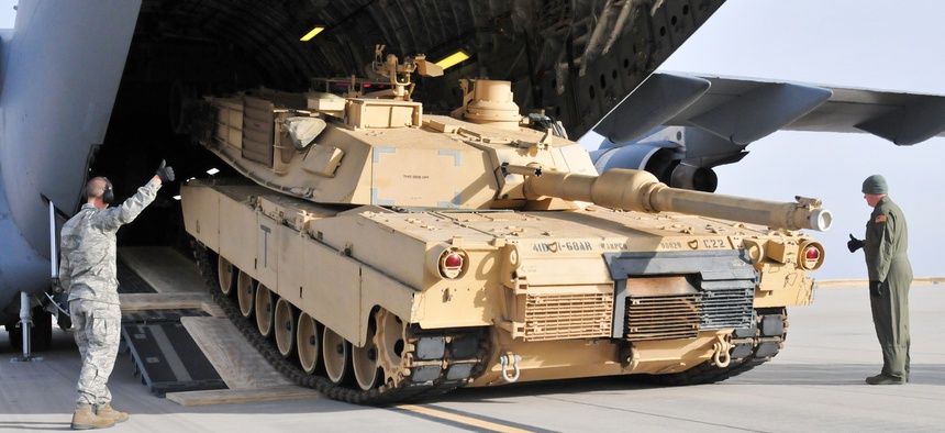 Soldiers from the 4th Infantry Division offload an M1A2 Abrams battle tank from a plane at Fort Carson, on January 13, 2014.