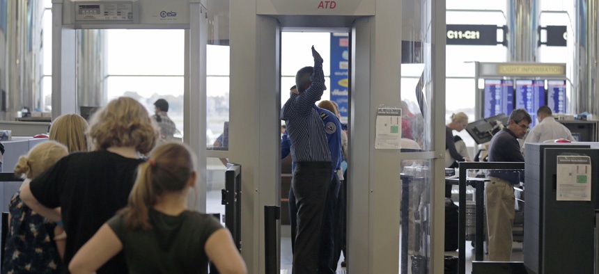 Passengers are scanned at a security checkpoint at Logan Airport, in Boston, on October 24, 2012.
